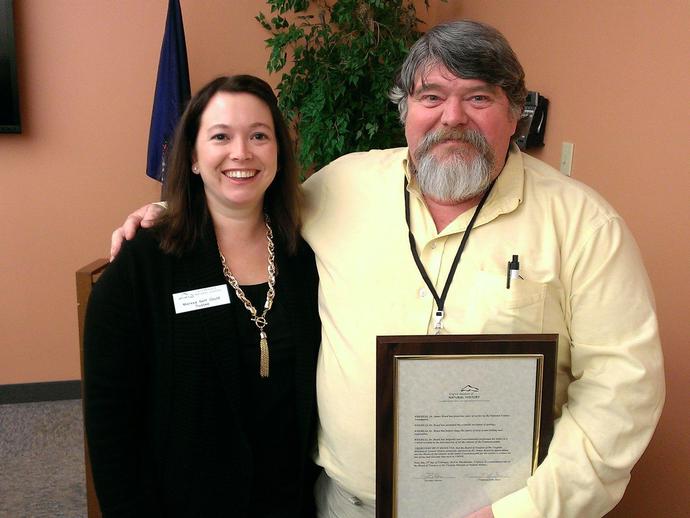 Dr Jim Beard receives a proclamation from the board of trustees (with Missy Neff Gould ...