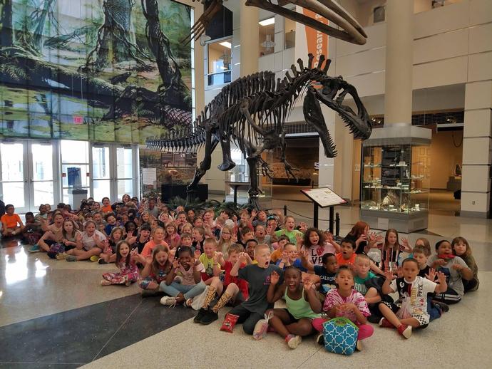 2nd graders from Gretna Elementary roared beside the museum's resident Acrocanthosaurus during a ...