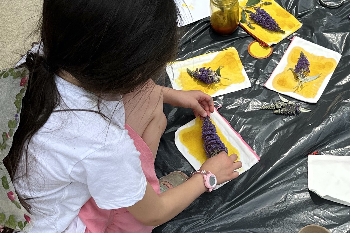 A camper indulges in outdoor nature art during last year's Summer Adventure Camps!